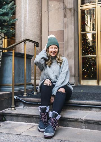 Caroline St Francis sitting outside in New York  on step wearing Cougar Vanetta Suede Mid Boot